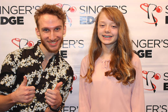 music lesson student walking red carpet with teacher at student performance