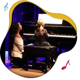 Toronto piano lesson teen student playing piano onstage with piano teacher