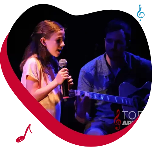 Toronto voice lesson girl student singing onstage with voice teacher