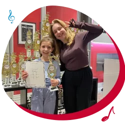 girl with music teacher winning Music reward for passing toronto music lesson test