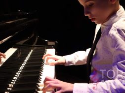 piano lesson student boy playing piano with both hands in shirt and tie_opt (1)