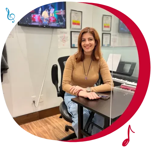 toronto music lesson teacher at desk with piano